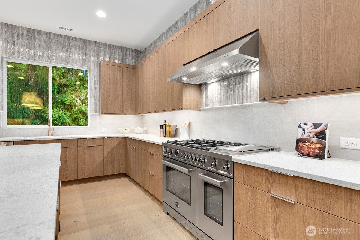 1455 153rd Place Southeast Bellevue, WA 98007 - Photo 12 of 39 a kitchen with a stove a sink and a microwave
