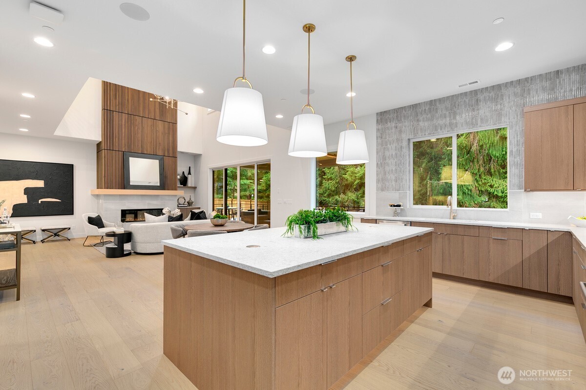1455 153rd Place Southeast Bellevue, WA 98007 - Photo 13 of 39 a large kitchen with a large counter top space appliances and a ceiling fan