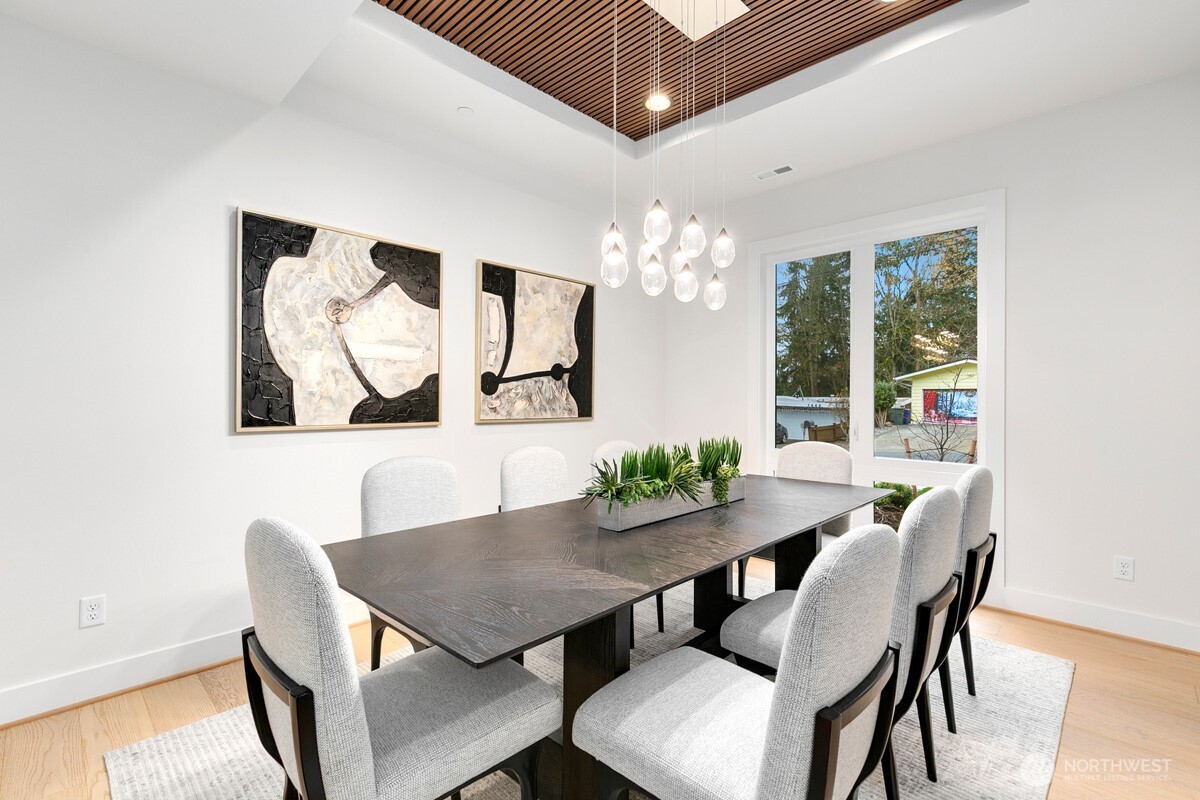 1455 153rd Place Southeast Bellevue, WA 98007 - Photo 15 of 39 a view of a dining room with furniture a chandelier and wooden floor
