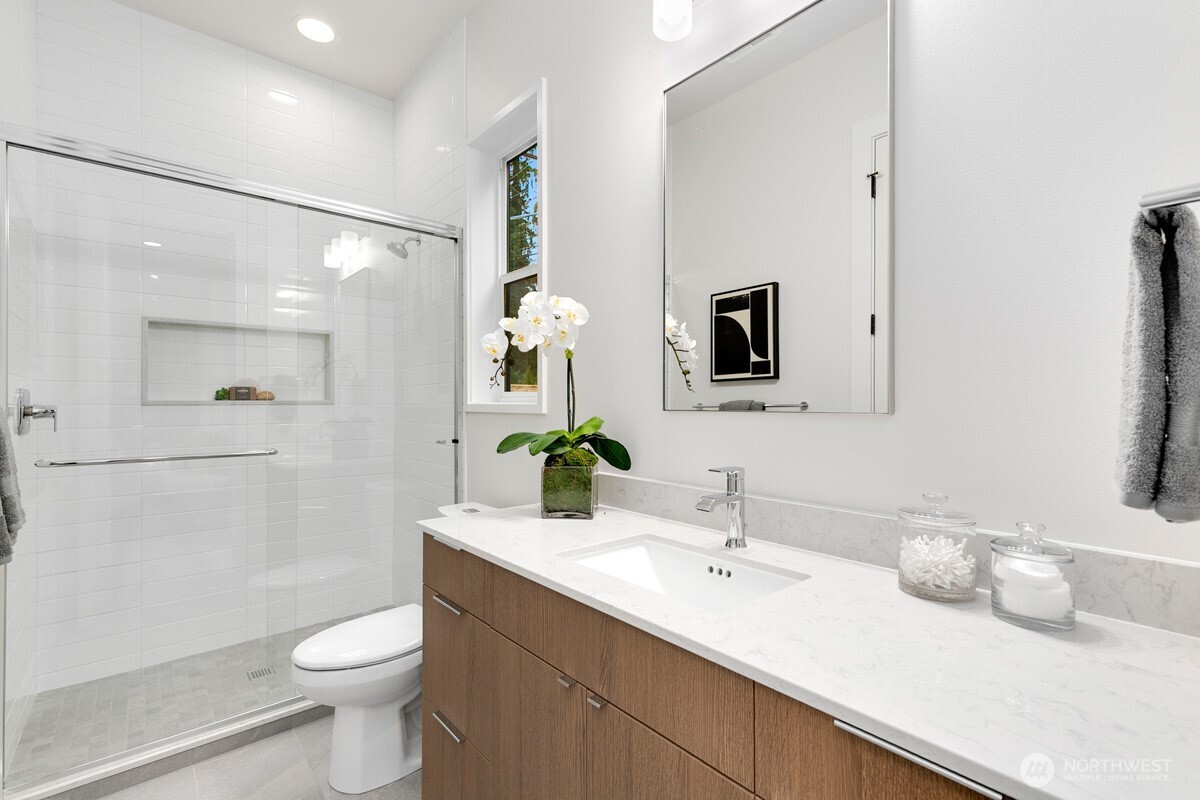 1455 153rd Place Southeast Bellevue, WA 98007 - Photo 32 of 39 a bathroom with a double vanity sink toilet and mirror