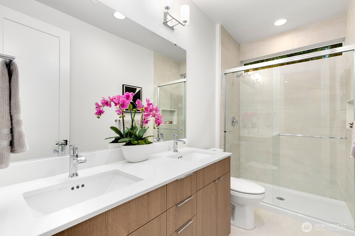 1455 153rd Place Southeast Bellevue, WA 98007 - Photo 35 of 39 a bathroom with a sink mirror shower and toilet