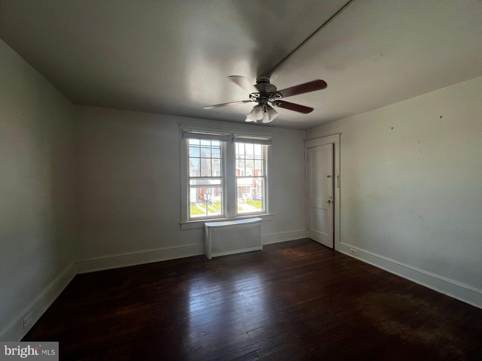 310 West Jackson Street York, PA 17401 - Photo 11 of 13 a view of an empty room with wooden floor and a window