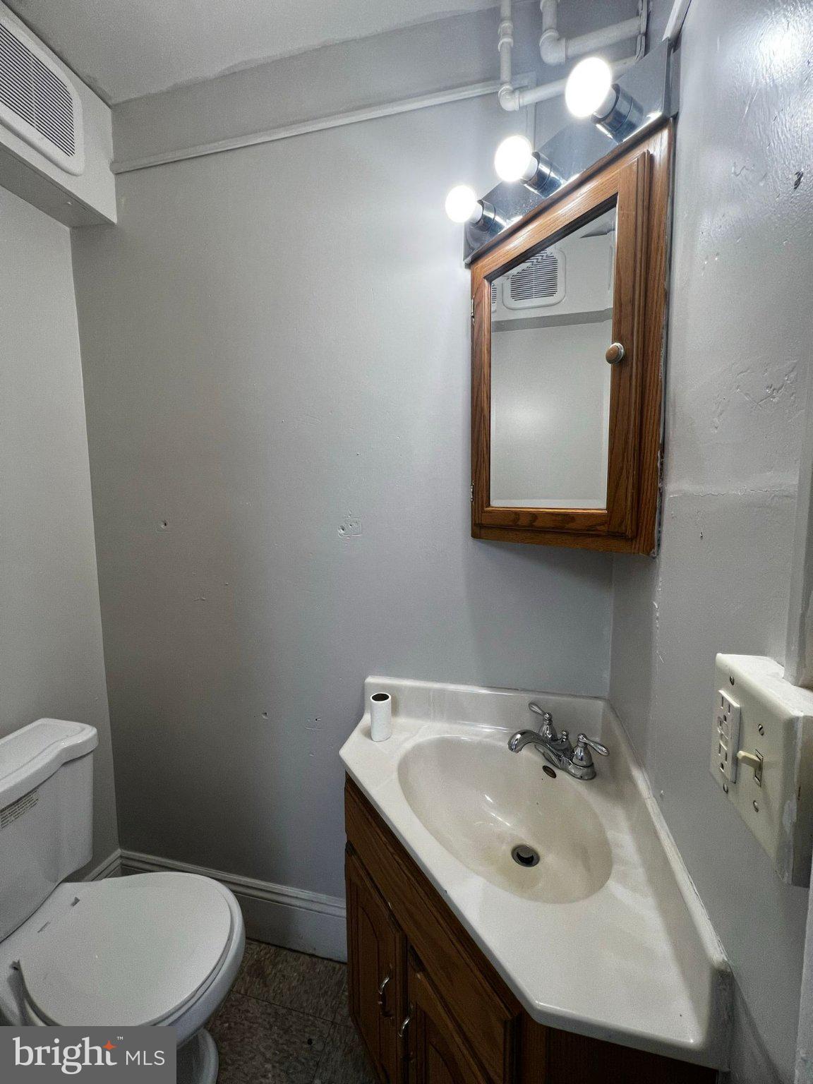 310 West Jackson Street York, PA 17401 - Photo 9 of 13 a bathroom with a toilet sink and mirror