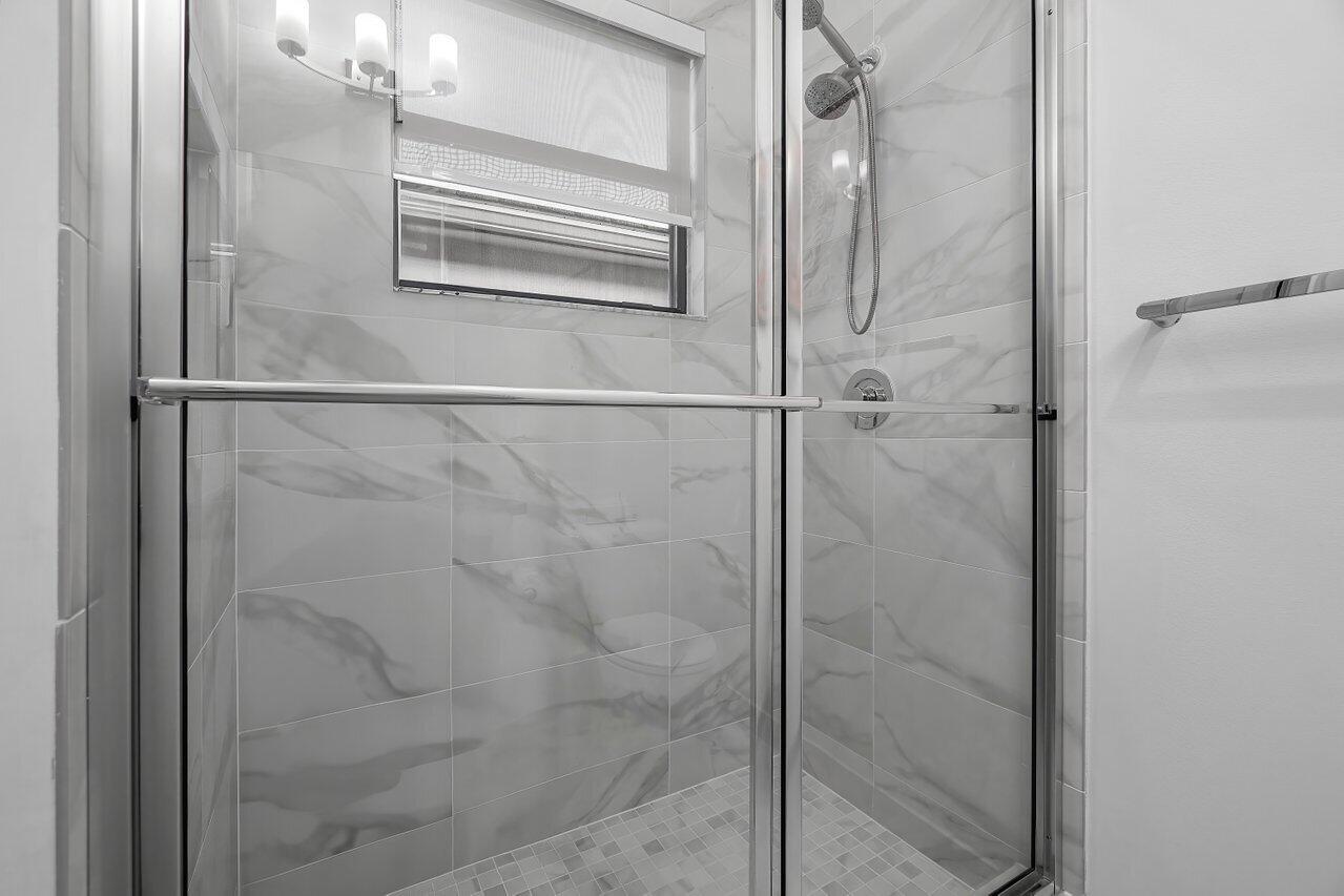 17092 Teton River Road Boca Raton, FL 33496 - Photo 19 of 58 a bathroom with a glass shower door
