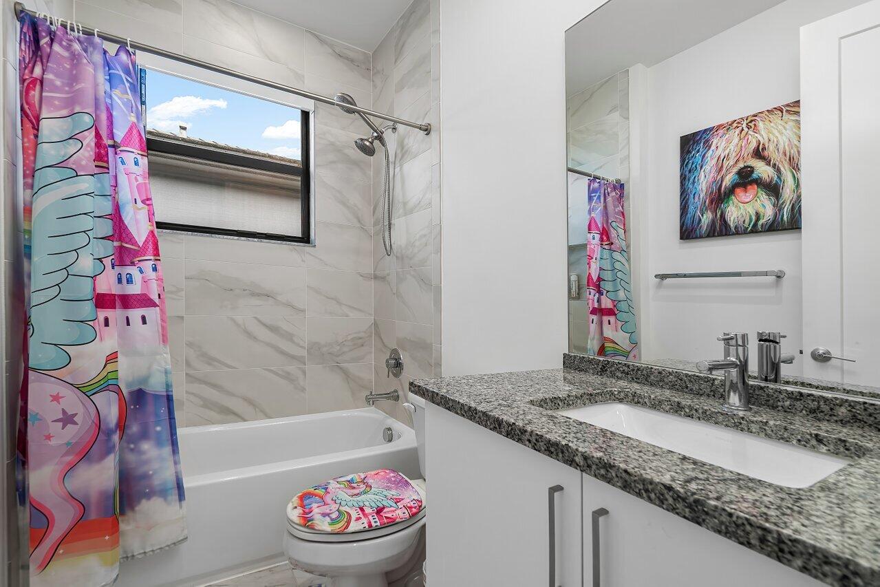 17092 Teton River Road Boca Raton, FL 33496 - Photo 23 of 58 a bathroom with a granite countertop sink and a mirror