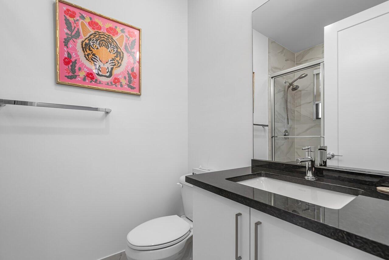 17092 Teton River Road Boca Raton, FL 33496 - Photo 27 of 58 a bathroom with a granite countertop sink mirror and toilet