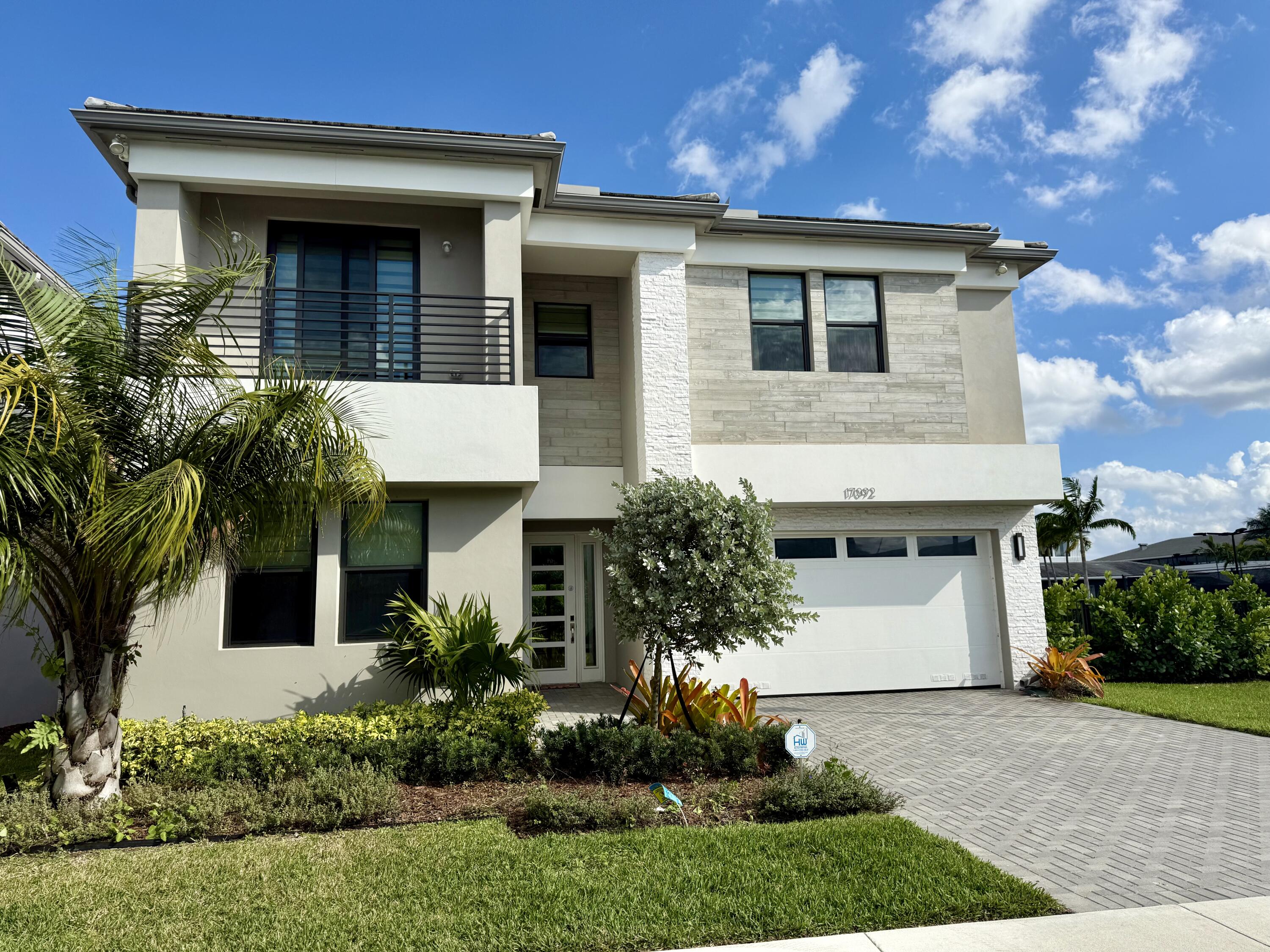 17092 Teton River Road Boca Raton, FL 33496 - Photo 40 of 58 a front view of a house with a garden