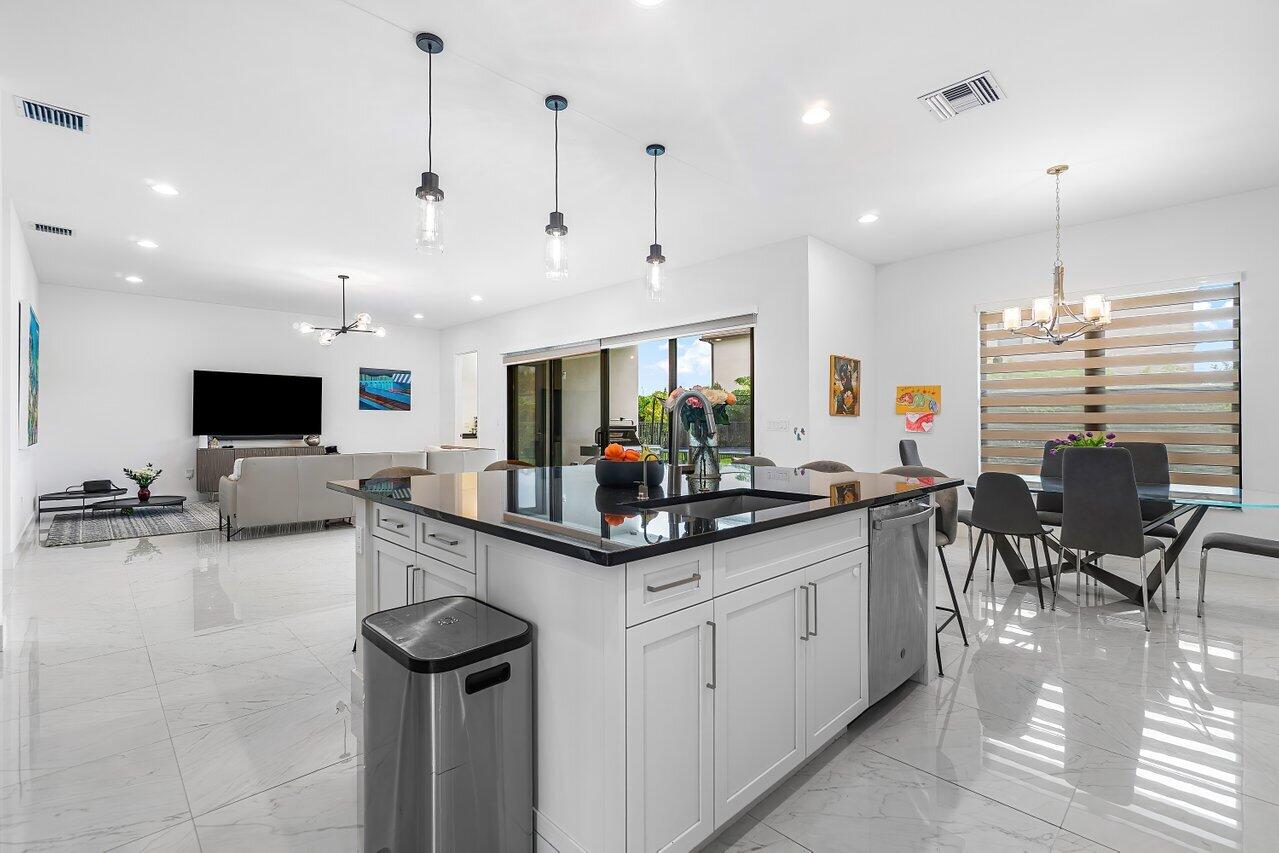 17092 Teton River Road Boca Raton, FL 33496 - Photo 5 of 58 a kitchen with stainless steel appliances kitchen island granite countertop a sink and a stove