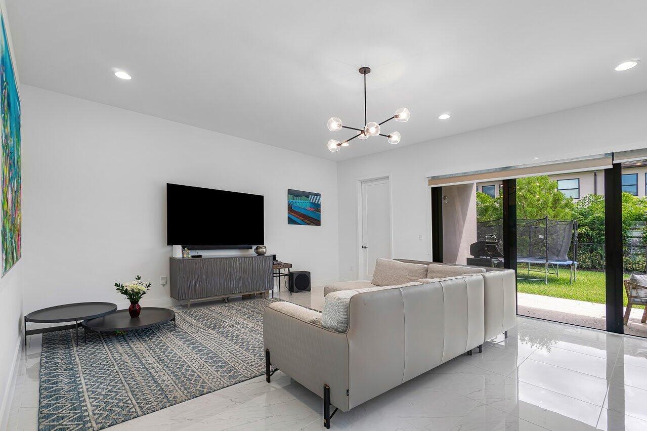 17092 Teton River Road Boca Raton, FL 33496 - Photo 8 of 58 a living room with furniture and a flat screen tv