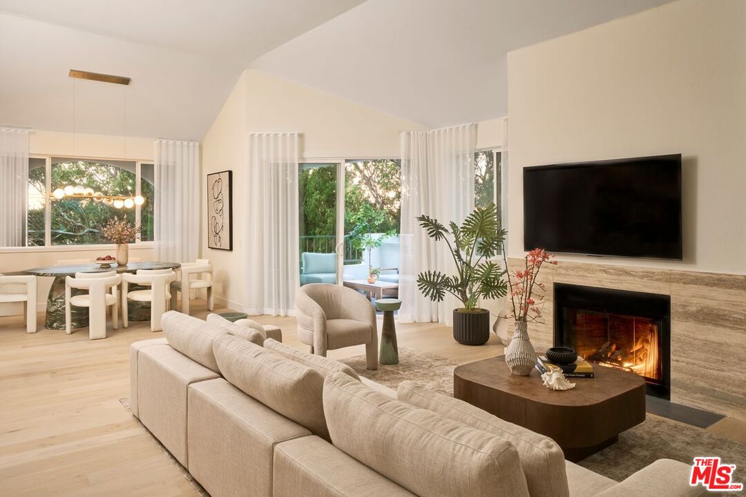 6489 Cavalleri Road, Unit 304 Malibu, CA 90265 - Photo 2 of 17 a living room with furniture fireplace and a flat screen tv