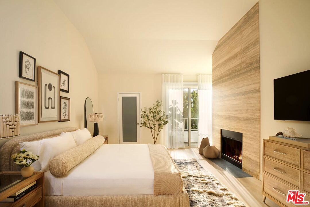 6489 Cavalleri Road, Unit 304 Malibu, CA 90265 - Photo 4 of 17 a bedroom with a bed and a flat screen tv