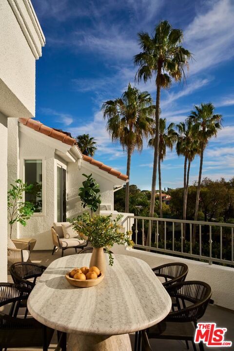 6489 Cavalleri Road, Unit 304 Malibu, CA 90265 - Photo 7 of 17 a view of a balcony dining area and swimming pool