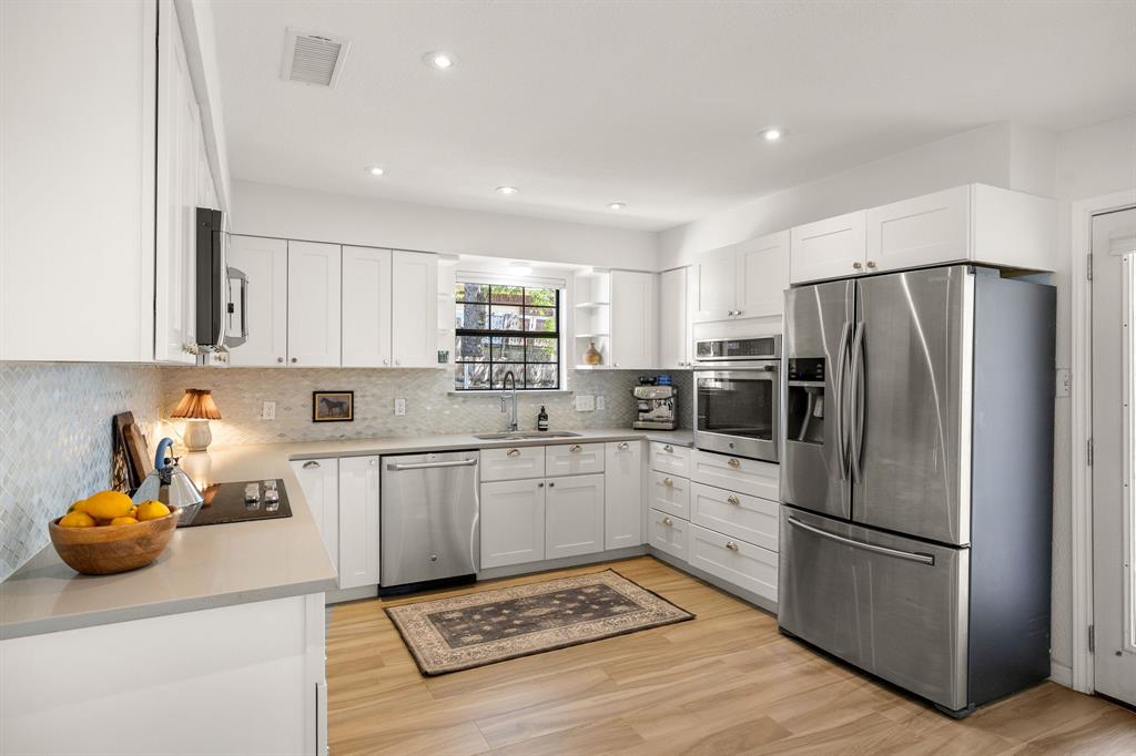 1729 Ryon Lane Round Rock, TX 78681 - Photo 4 of 27 Solid surface countertops and updated backsplash.