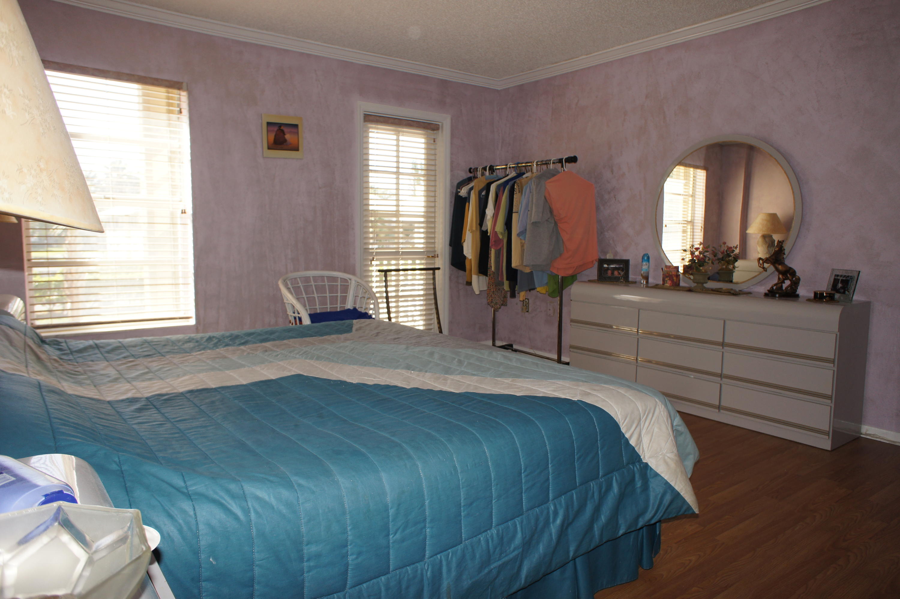 951 De Soto Road, Unit 234 Boca Raton, FL 33432 - Photo 41 of 44 a bedroom with a bed and a mirror on dresser