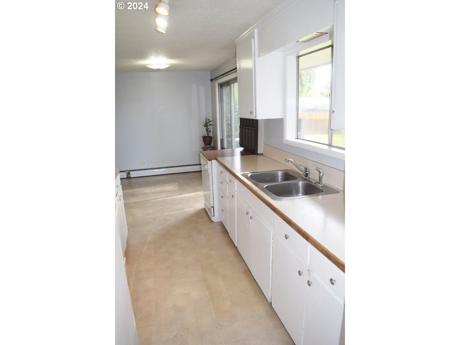 1822 Southwest 44th Street Pendleton, OR 97801 - Photo 9 of 22 a kitchen with granite countertop white cabinets and sink