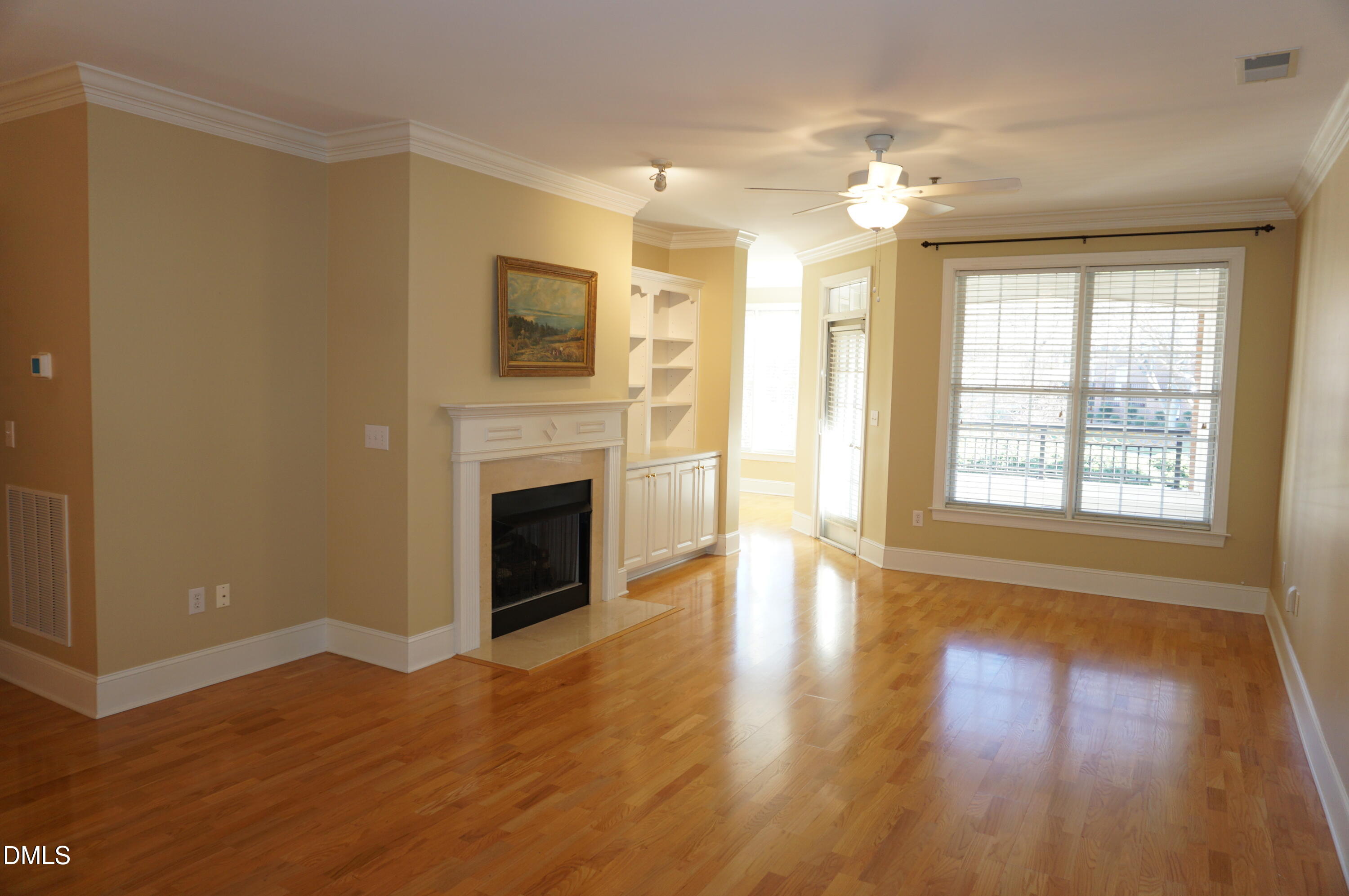3701 Baron Cooper Pass, Unit 104 Raleigh, NC 27612 - Photo 17 of 52 a view of a livingroom with a fireplace wooden floor and windows