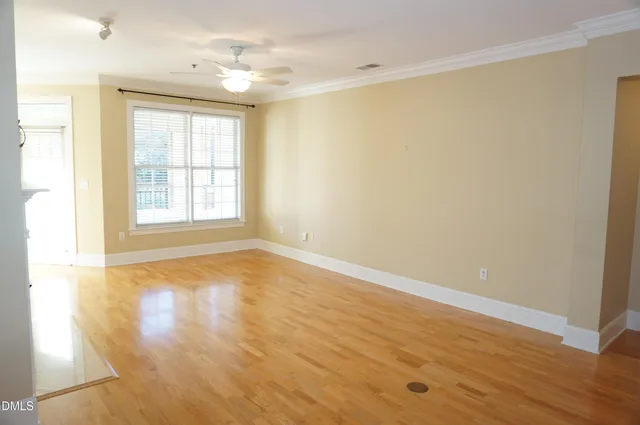 a living room with a fireplace and a floor to ceiling window