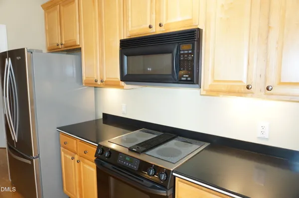a stove top oven sitting inside of a kitchen