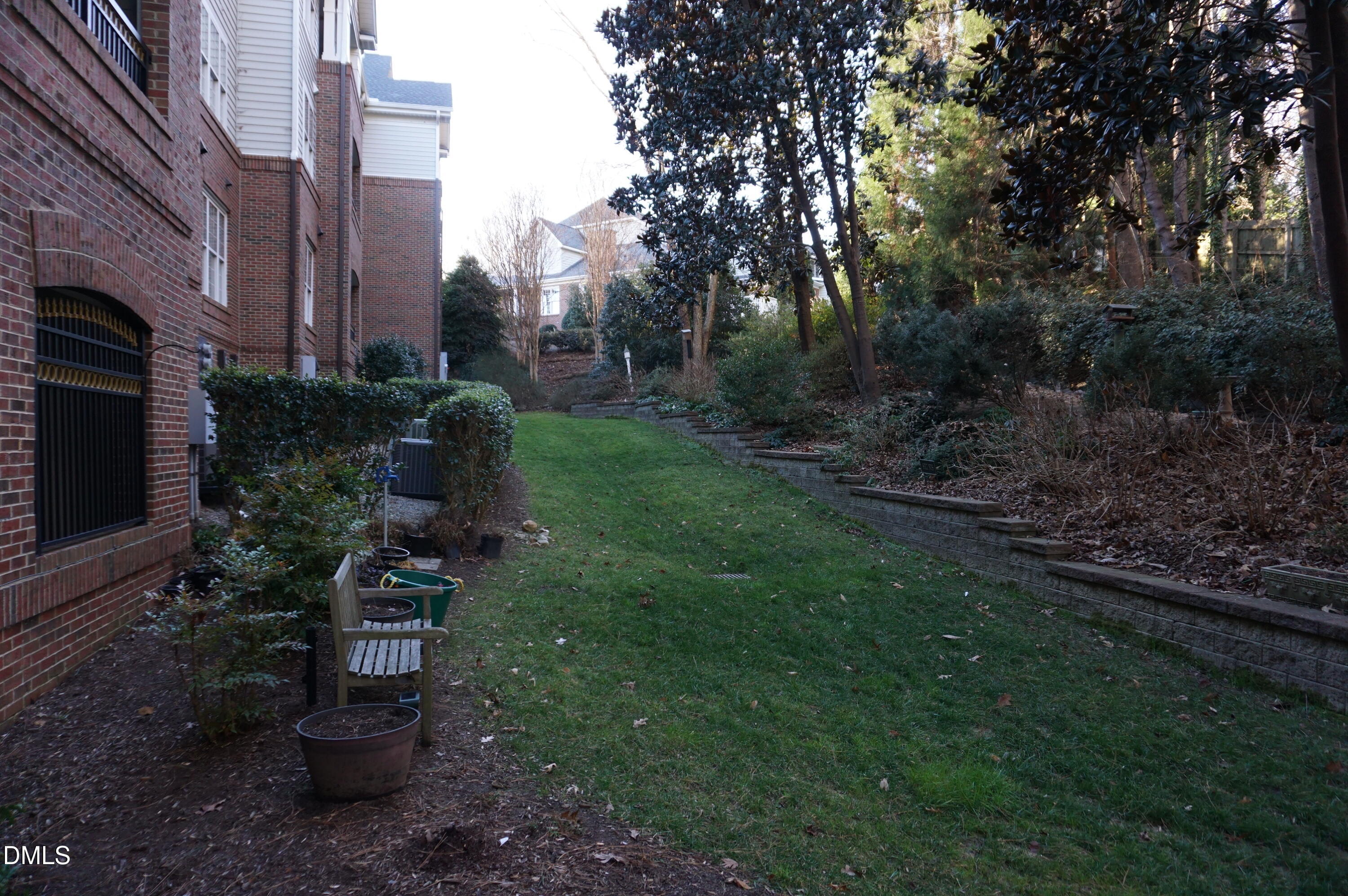 3701 Baron Cooper Pass, Unit 104 Raleigh, NC 27612 - Photo 51 of 52 a view of a garden with a bench