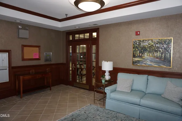 a living room with furniture a rug and a painting on the wall