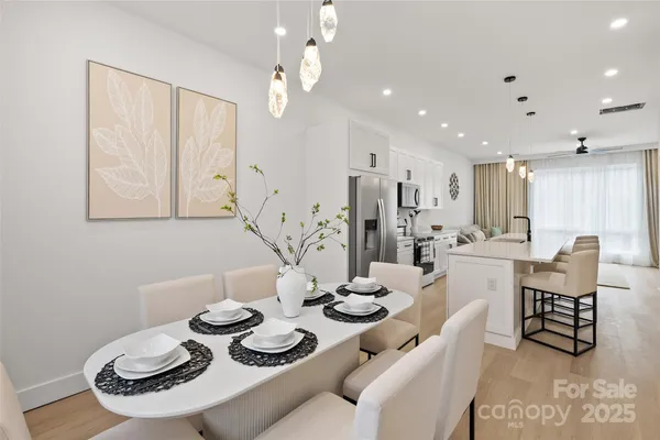 a dining room with furniture and a chandelier