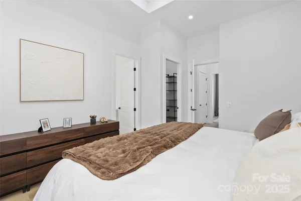 a bedroom with a bed and a lamp