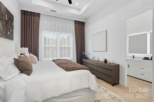 a bedroom with a bed and a large window