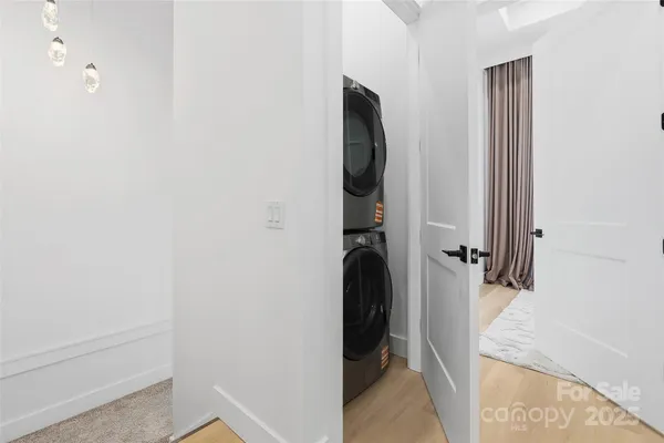a view of a hallway with bathroom and shower