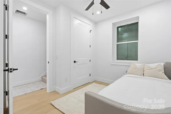 a bedroom with a bed and a painting on the wall