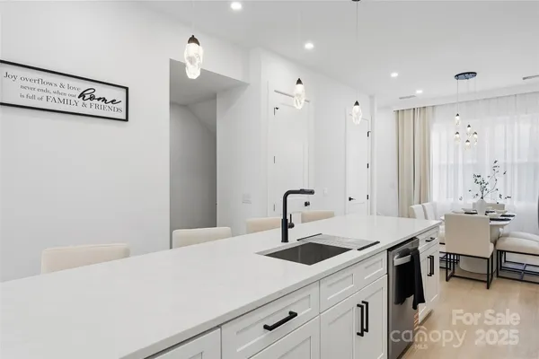 a kitchen with a sink cabinets and wooden floor