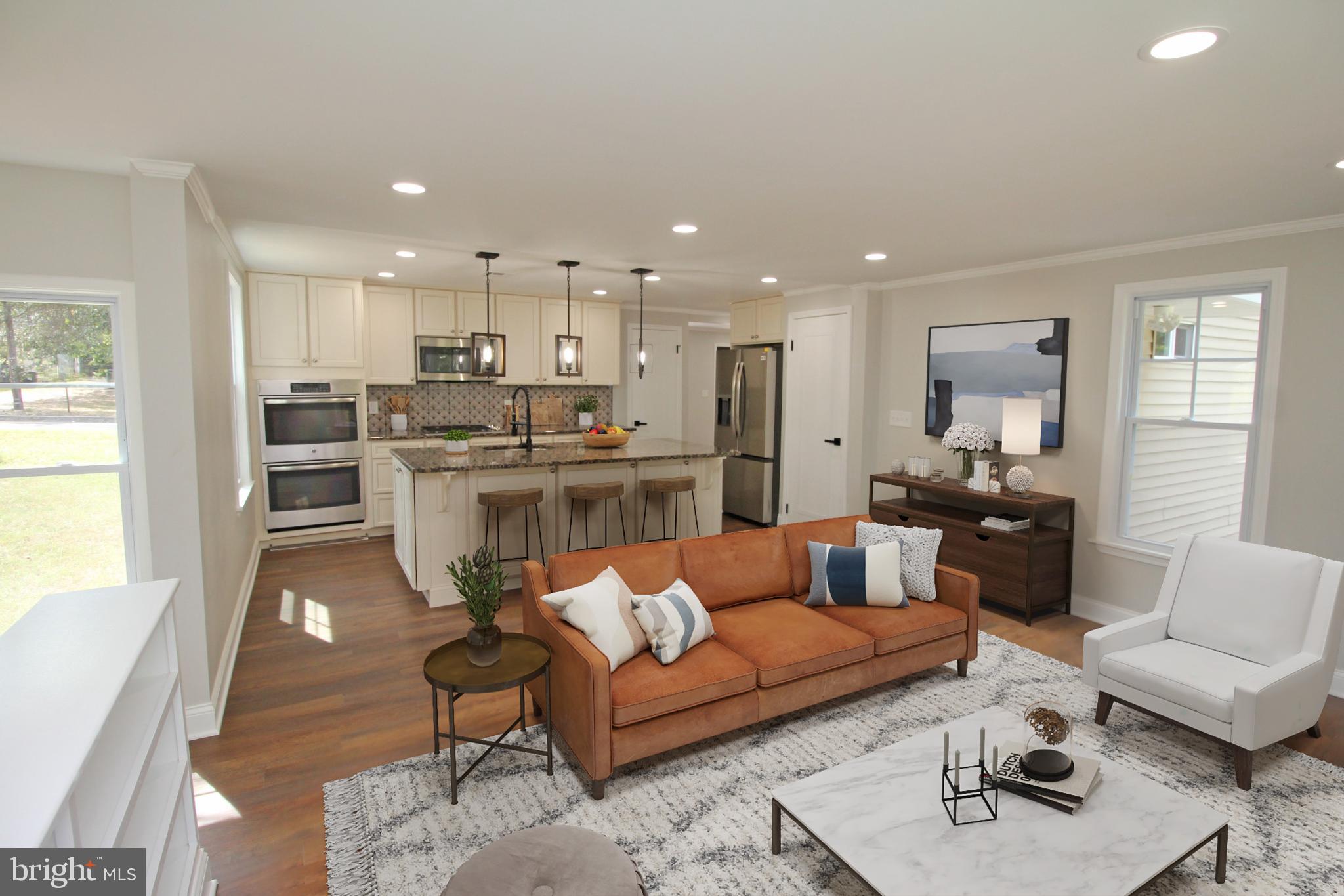 1588 Kearsley Road Sicklerville, NJ 08081 - Photo 11 of 36 a living room with stainless steel appliances kitchen island granite countertop furniture and a wooden floor