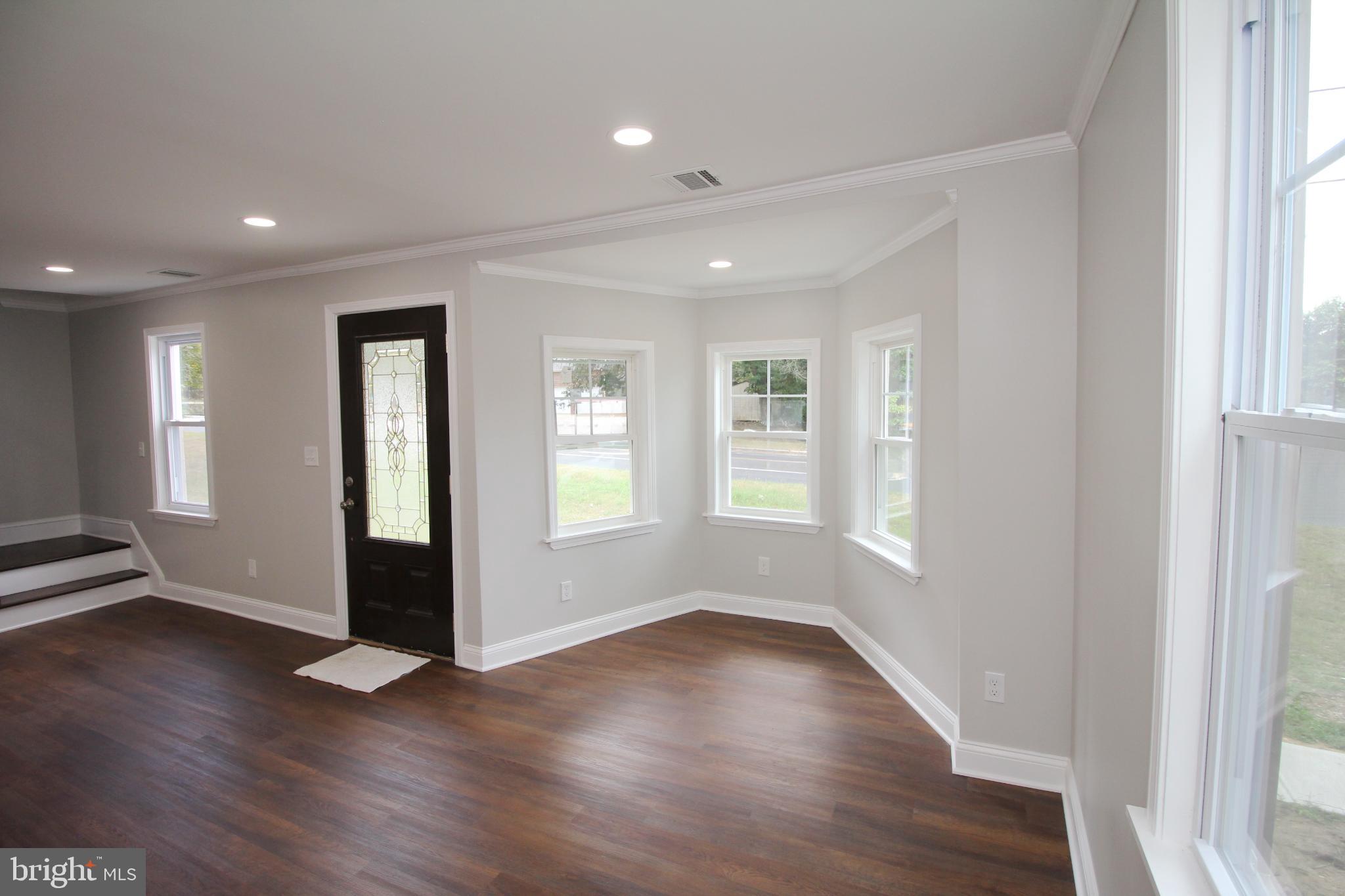 1588 Kearsley Road Sicklerville, NJ 08081 - Photo 12 of 36 an empty room with wooden floor and windows