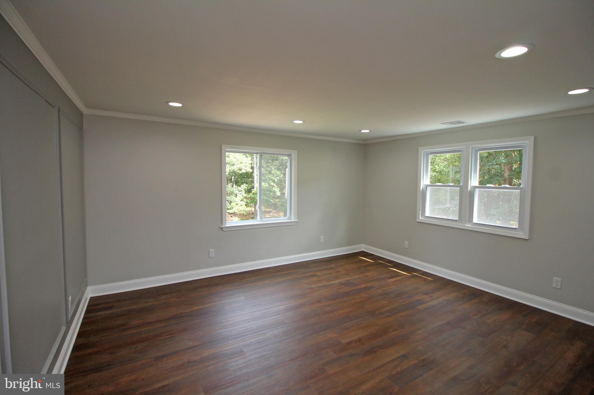 1588 Kearsley Road Sicklerville, NJ 08081 - Photo 19 of 36 an empty room with wooden floor and windows