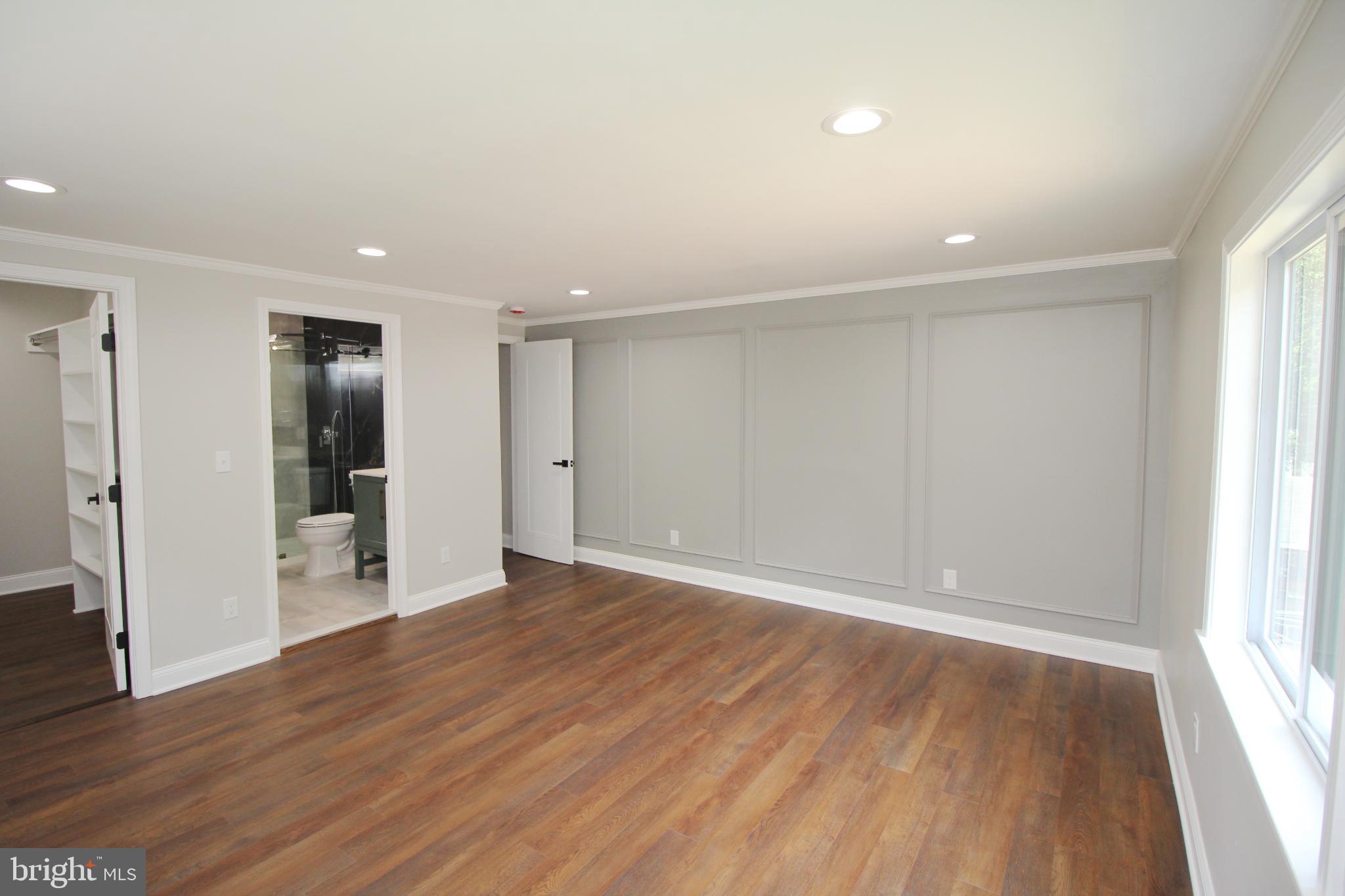 1588 Kearsley Road Sicklerville, NJ 08081 - Photo 20 of 36 an empty room with wooden floor and windows