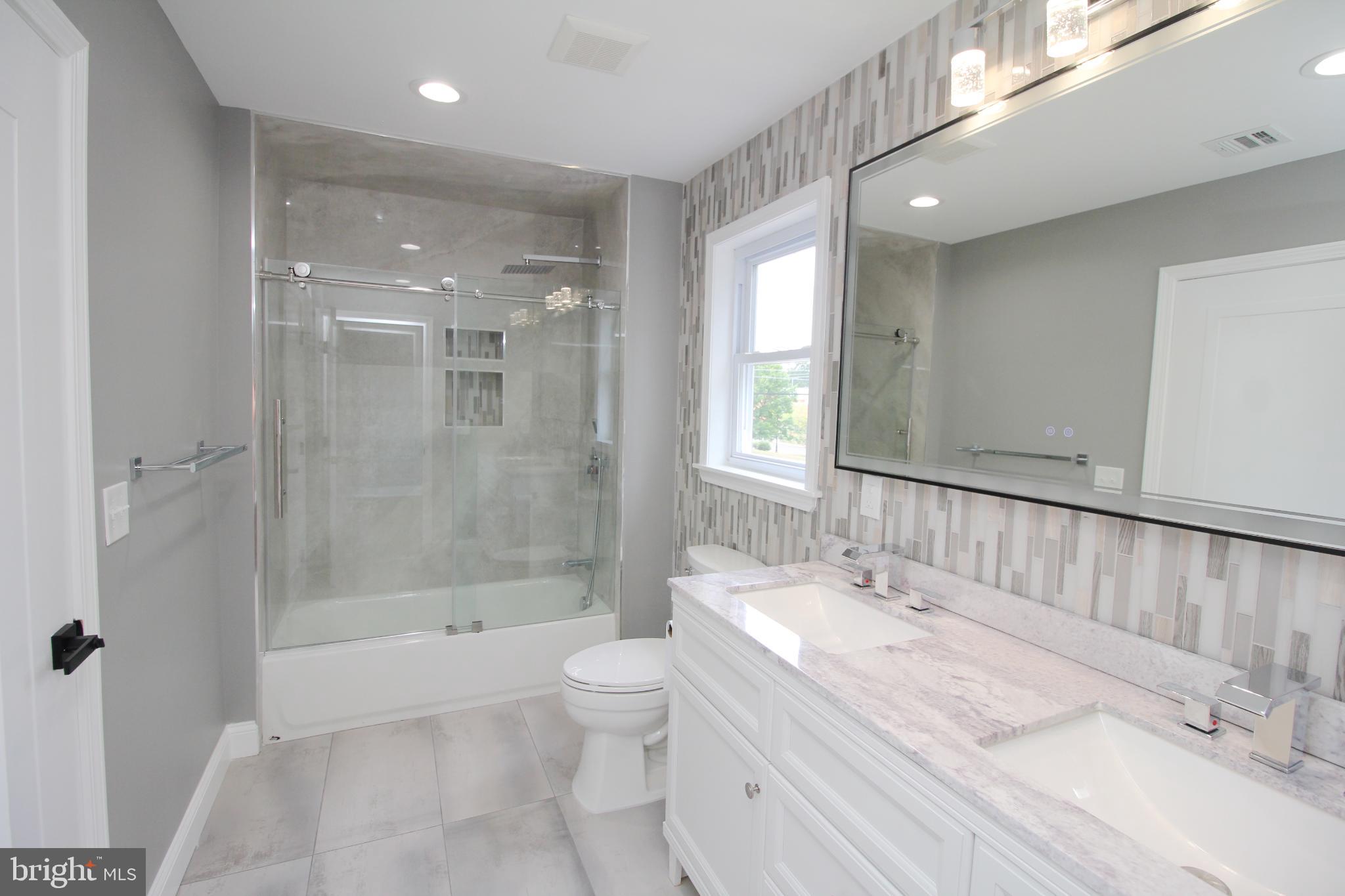 1588 Kearsley Road Sicklerville, NJ 08081 - Photo 27 of 36 a bathroom with a granite countertop sink a toilet and shower
