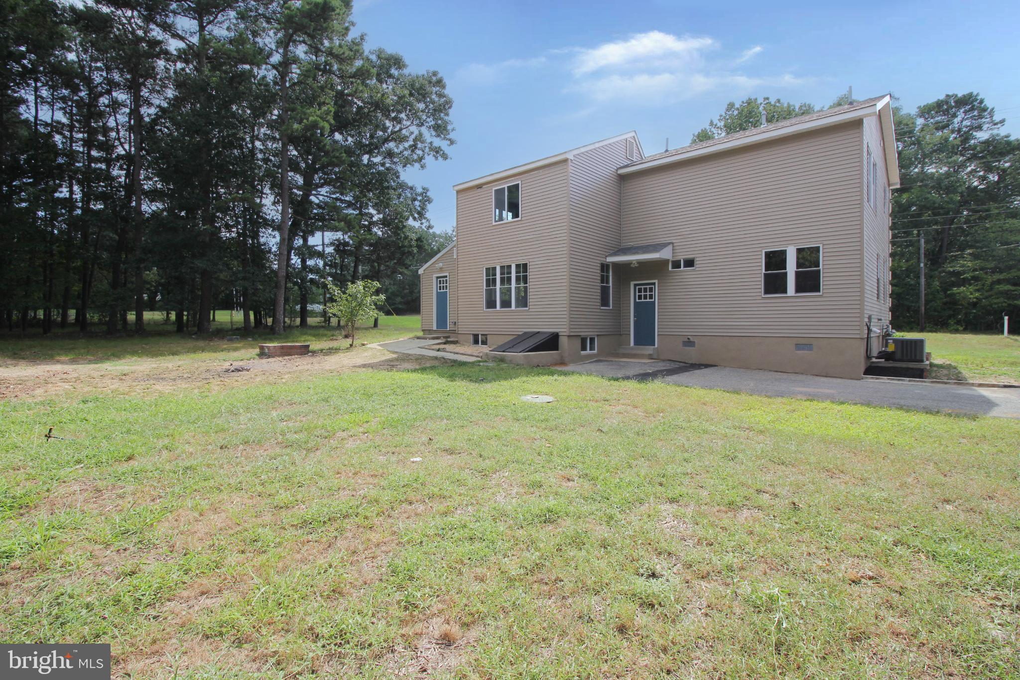 1588 Kearsley Road Sicklerville, NJ 08081 - Photo 5 of 36 a view of a backyard with a garden and fire pit