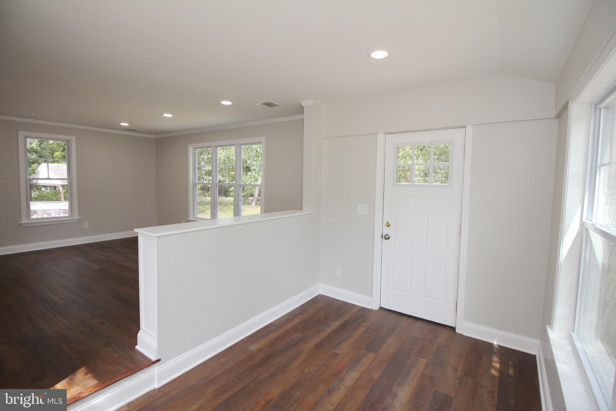 1588 Kearsley Road Sicklerville, NJ 08081 - Photo 9 of 36 an empty room with wooden floor and windows