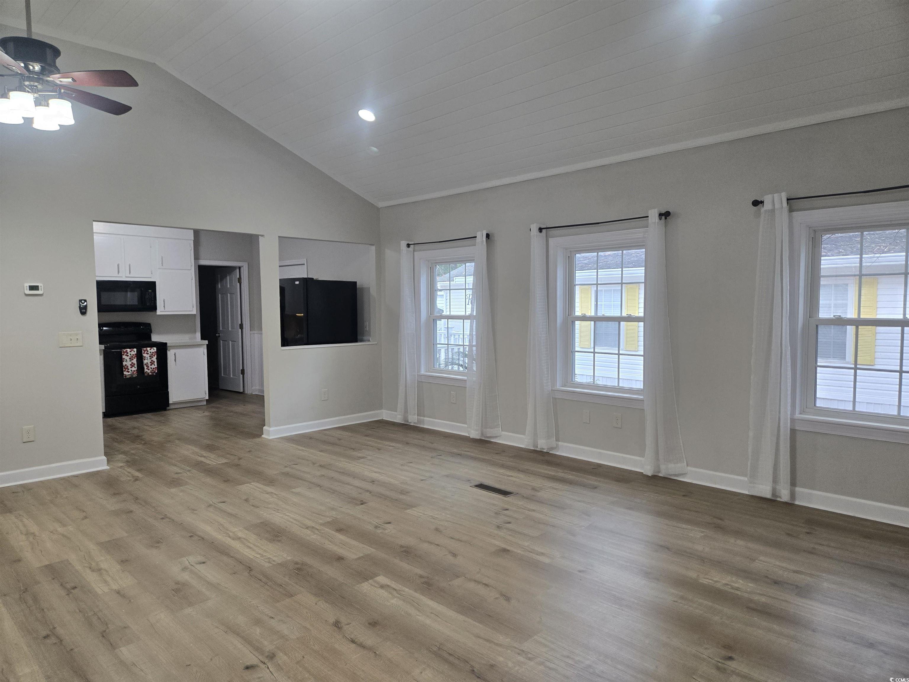 517 Porter Drive Murrells Inlet, SC 29576 - Photo 15 of 40 Unfurnished living room featuring vaulted ceiling, light wood-type flooring, a ceiling fan, and recessed lighting