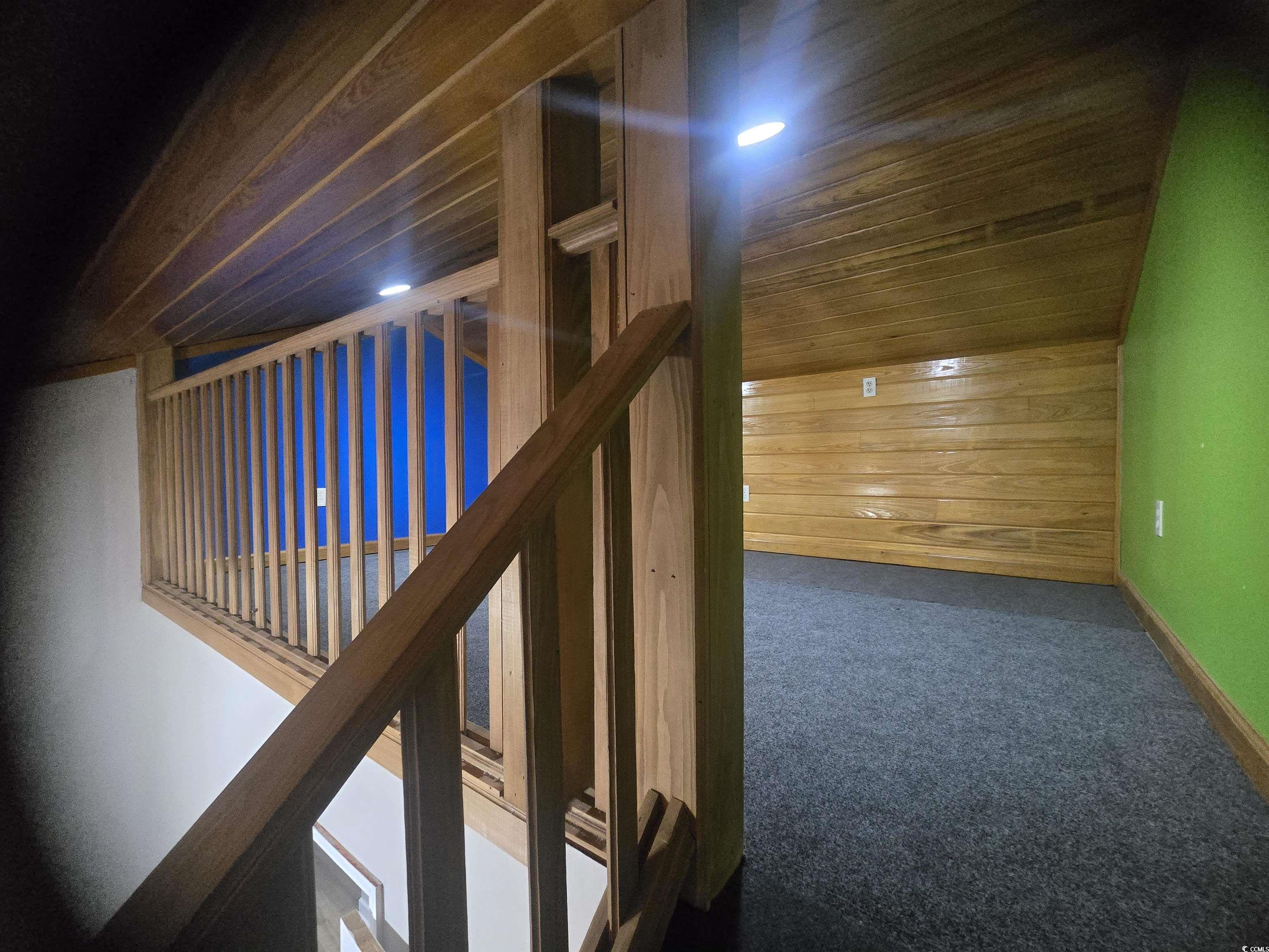 517 Porter Drive Murrells Inlet, SC 29576 - Photo 19 of 40 Staircase with wooden ceiling, wooden walls, and carpet flooring