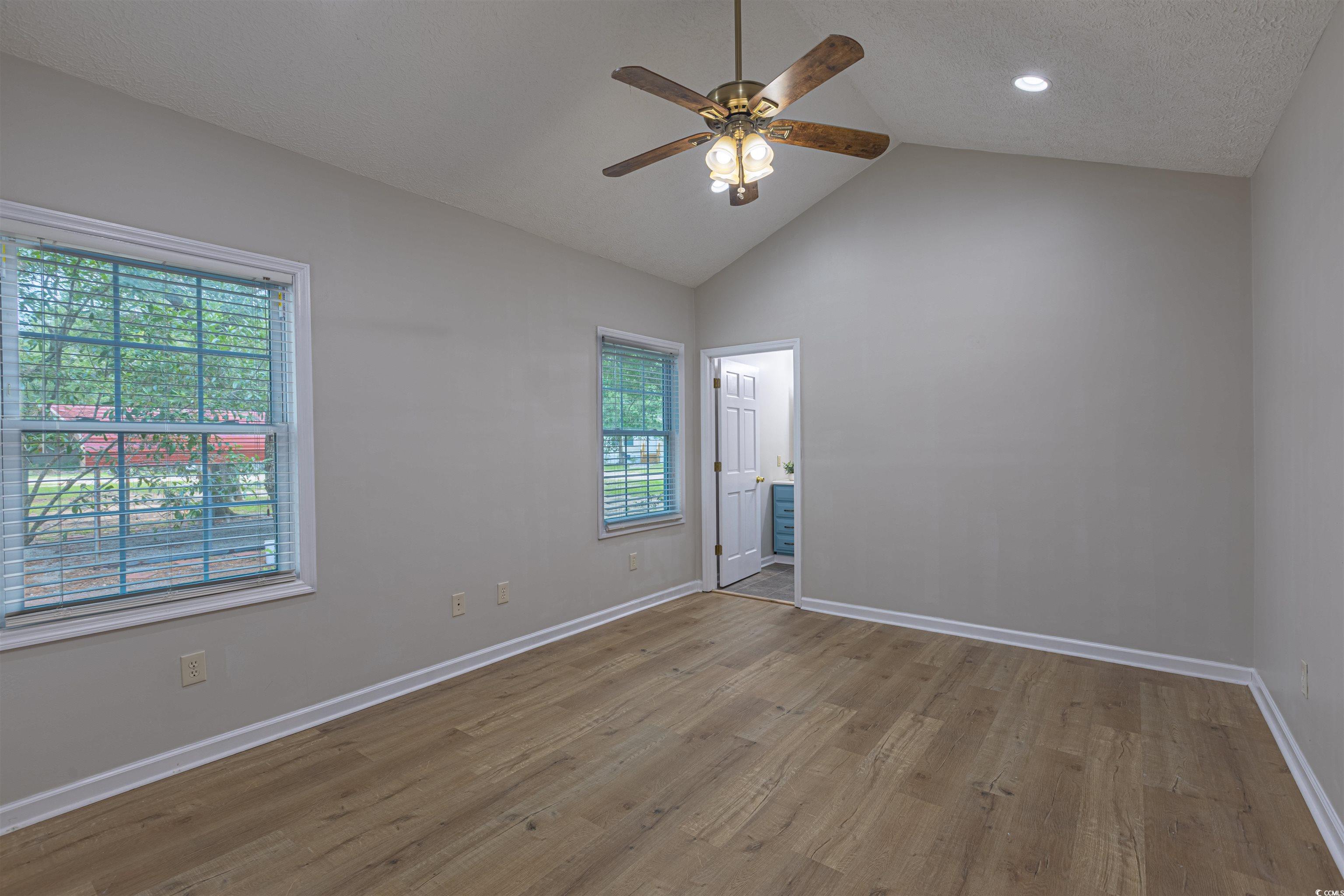 517 Porter Drive Murrells Inlet, SC 29576 - Photo 25 of 40 Empty room featuring wood finished floors, a ceiling fan, a textured ceiling, high vaulted ceiling, and recessed lighting