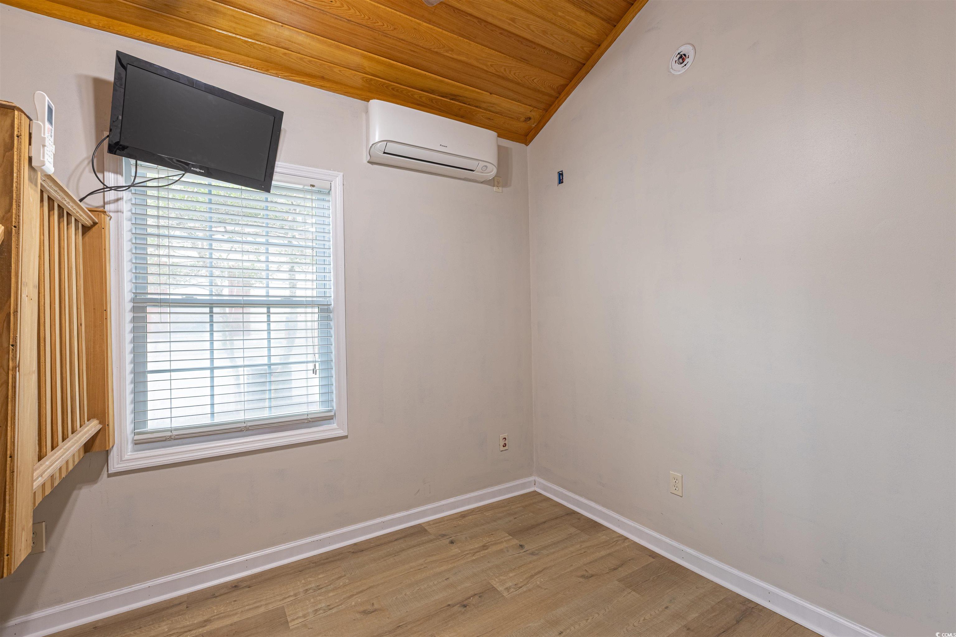 517 Porter Drive Murrells Inlet, SC 29576 - Photo 31 of 40 Empty room with wooden ceiling, light wood-style floors, lofted ceiling, and an AC wall unit