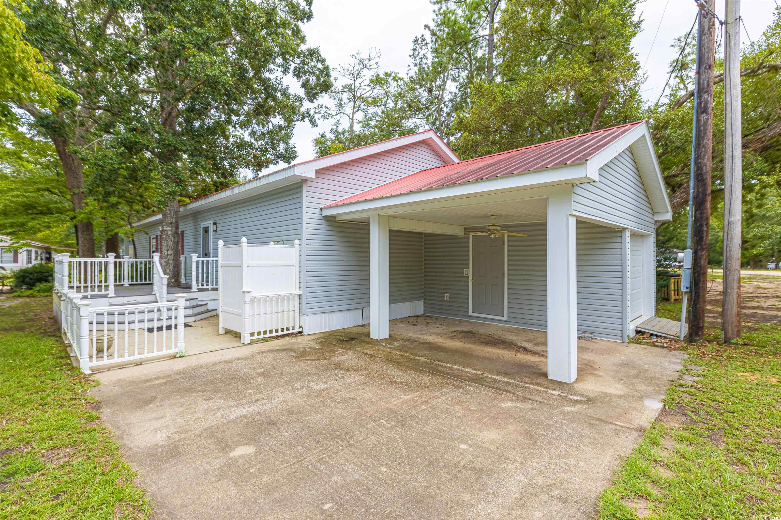 517 Porter Drive Murrells Inlet, SC 29576 - Photo 6 of 40 View of front of house with a carport, a metal roof, ceiling fan, and concrete driveway