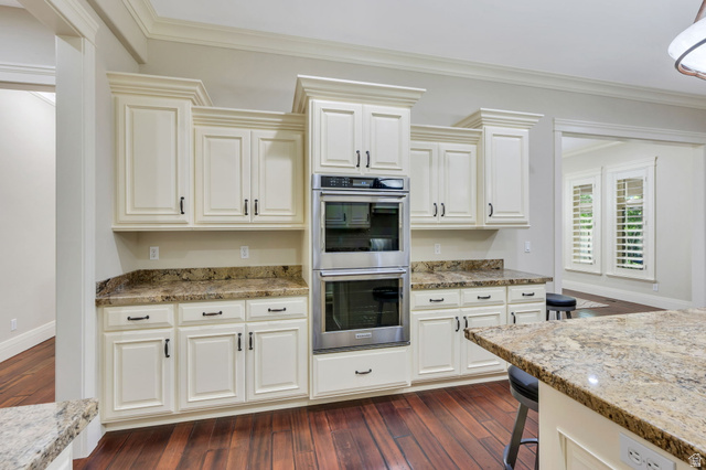 650 East Center Street Alpine, UT 84004 - Photo 12 of 38 Kitchen featuring cream-colored cabinetry, stainless steel double wall ovens, rich wood-finish flooring, and granite countertops