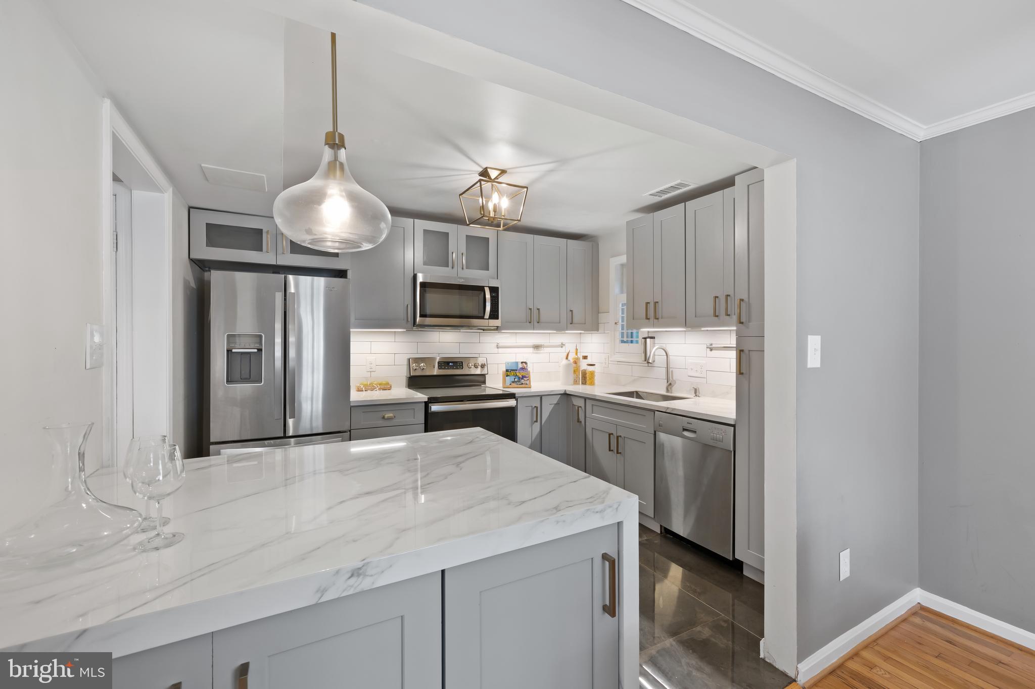 a kitchen with cabinets and stainless steel appliances