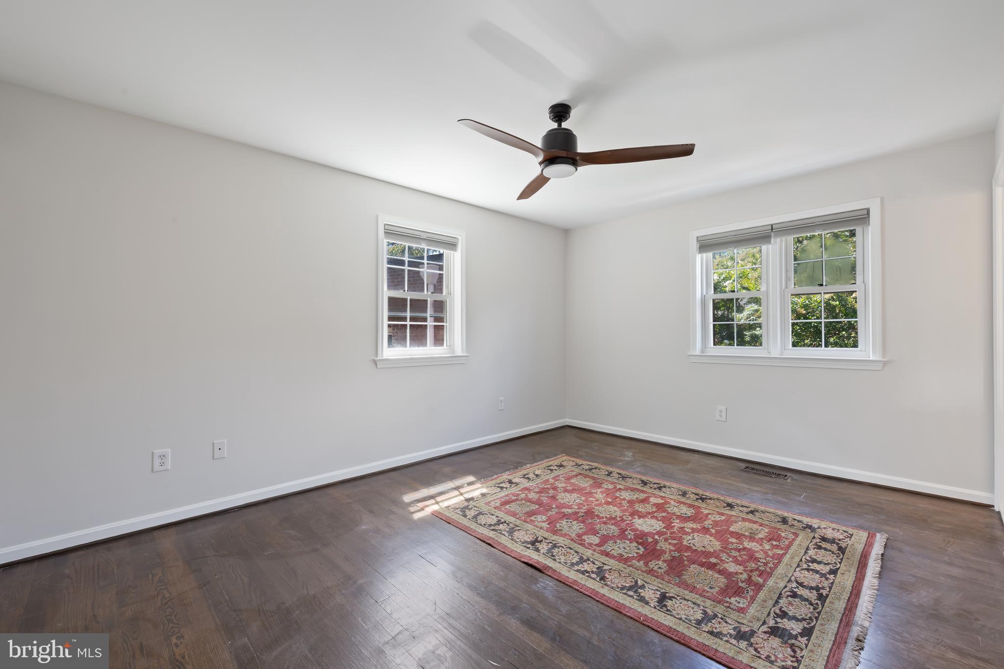 6721 Kenwood Forest Lane, Unit 45 Chevy Chase, MD 20815 - Photo 15 of 35 a view of an empty room with window and wooden floor