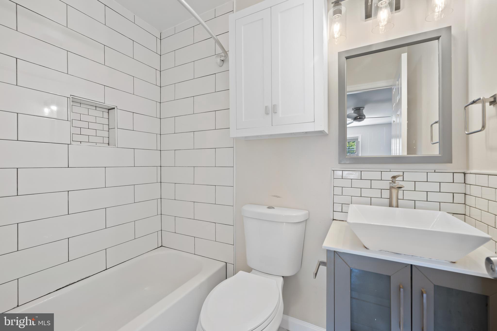 6721 Kenwood Forest Lane, Unit 45 Chevy Chase, MD 20815 - Photo 22 of 35 a bathroom with a sink toilet and shower