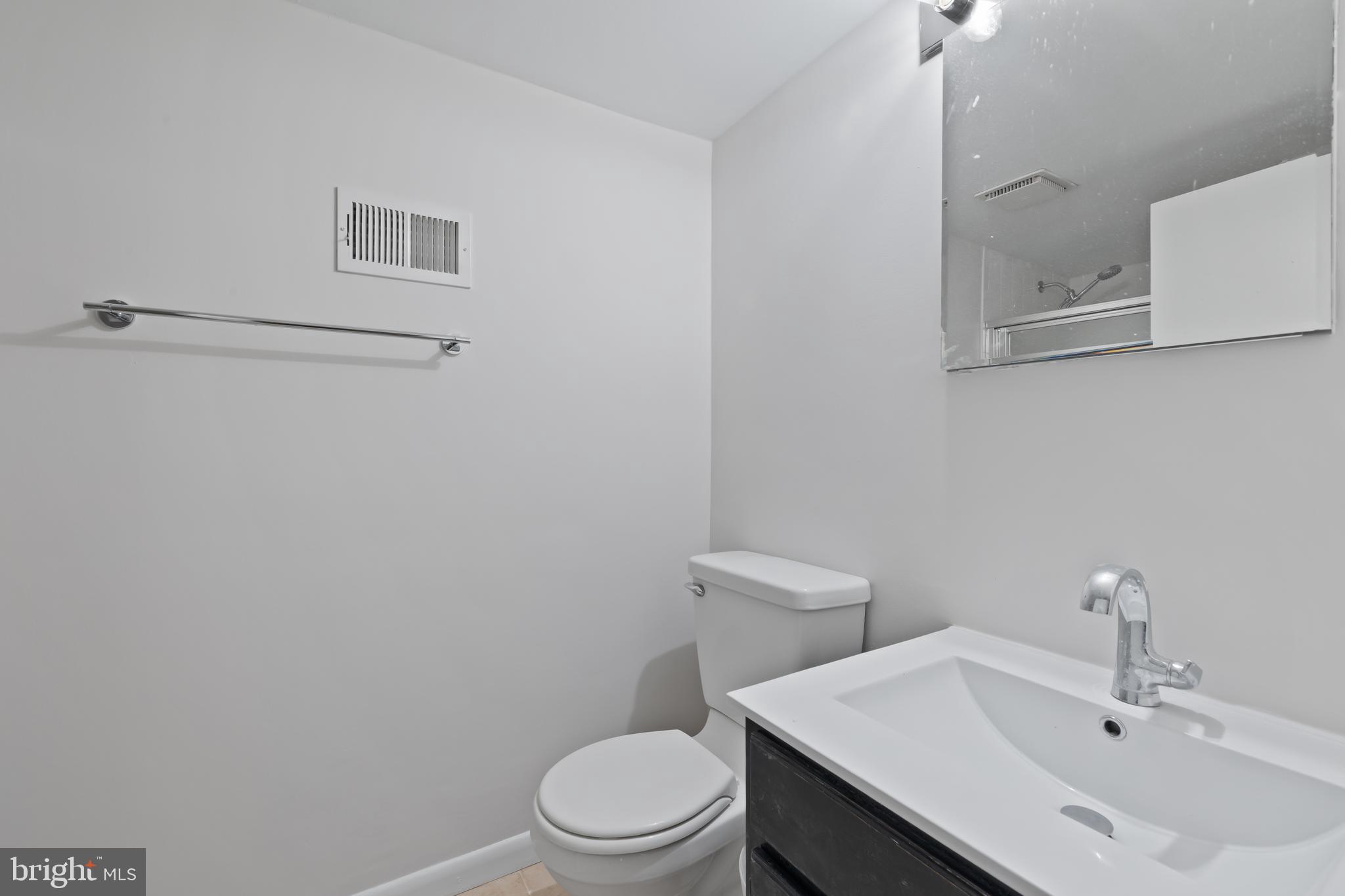 6721 Kenwood Forest Lane, Unit 45 Chevy Chase, MD 20815 - Photo 27 of 35 a bathroom with a sink a toilet and mirror