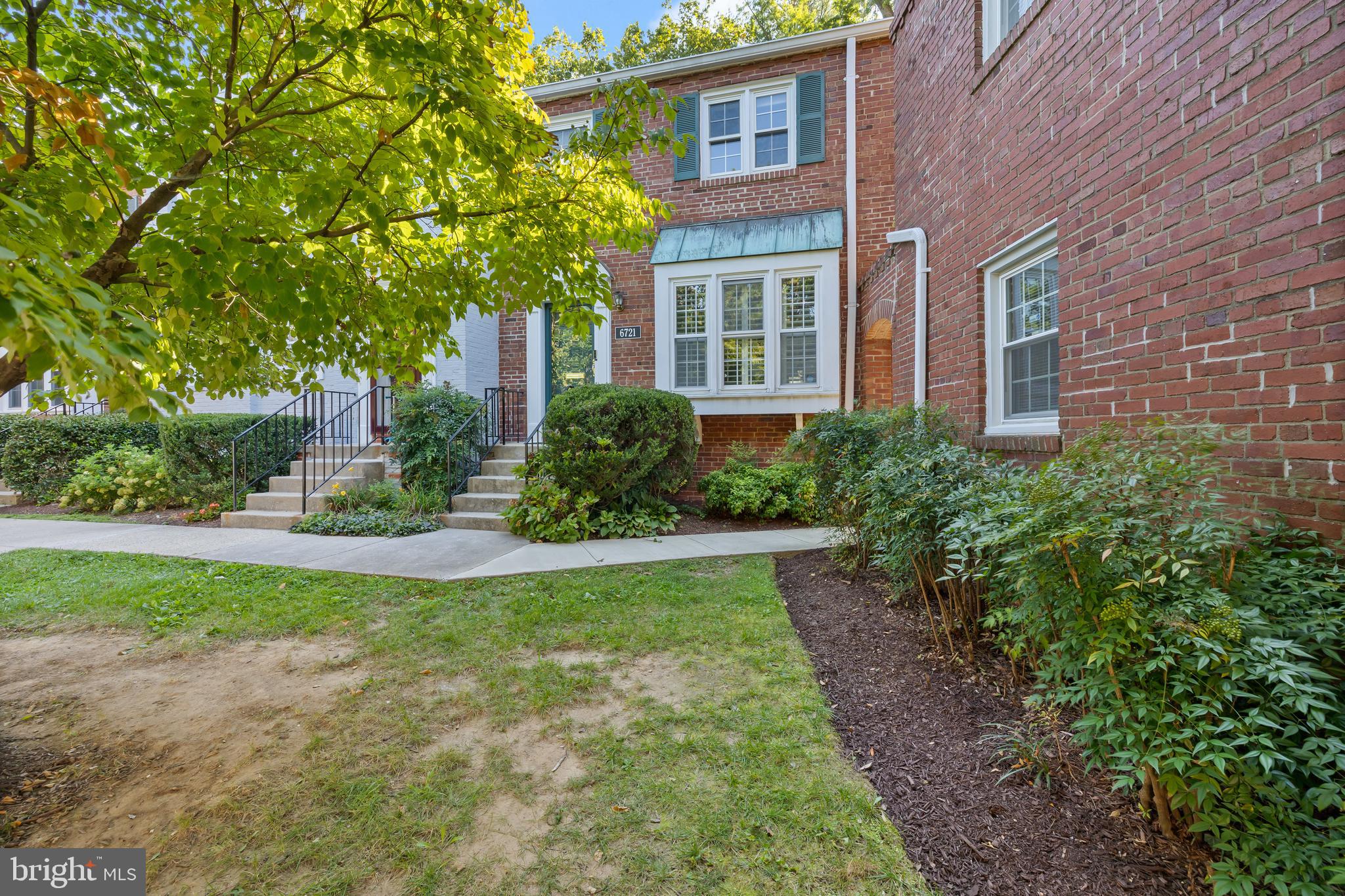 6721 Kenwood Forest Lane, Unit 45 Chevy Chase, MD 20815 - Photo 33 of 35 a front view of a house with garden