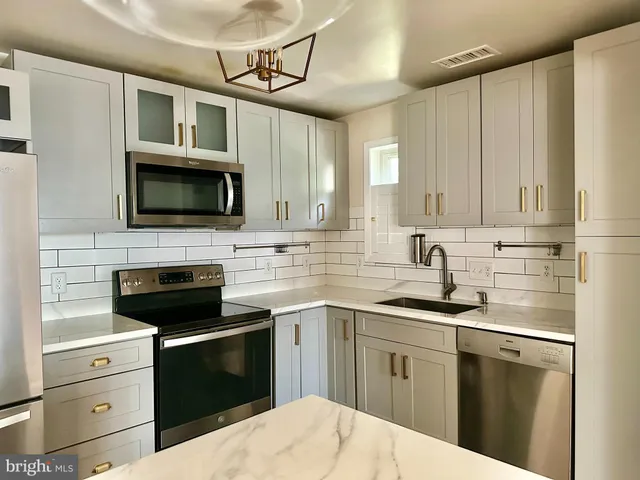 a view of a livingroom with wooden floor and a window