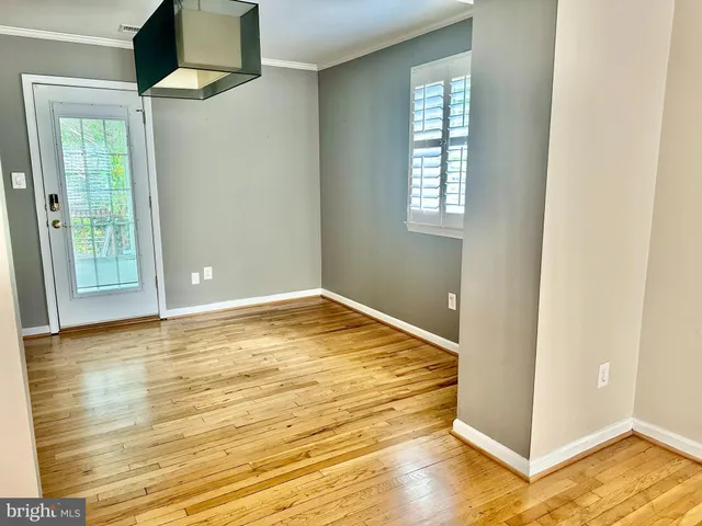 a front view of a house with a tree and a yard